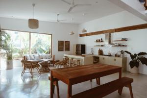 a kitchen and living room with a table and chairs at Punta Punta Surf Retreat in General Luna