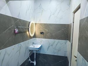 a bathroom with a sink and a mirror at hariholidaysvilla in Chennai +7 photos