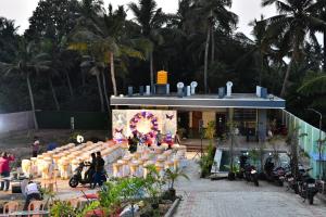 a group of people standing in front of a building at hariholidaysvilla in Chennai