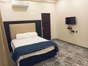 a bedroom with a bed and a tv in it at hariholidaysvilla in Chennai