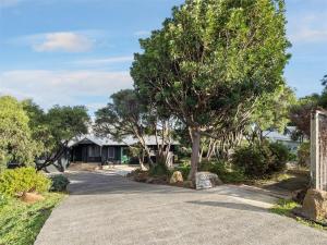 a driveway with trees in front of a house at Baudin Beach House in Gnarabup