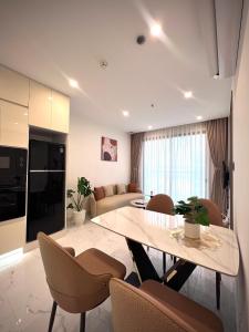 a living room with a table and chairs at MH Home in Long Bình +14 photos