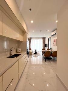 a kitchen and living room with a table and a dining room at MH Home in Long Bình