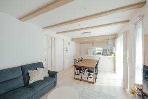 a living room with a couch and a table at Quiet Japanese House near Airport in Kumamoto