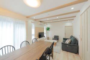 a living room with a table and chairs and a couch at Quiet Japanese House near Airport in Kumamoto