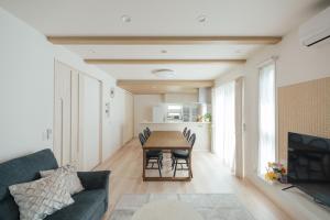 a living room with a table and a couch at Quiet Japanese House near Airport in Kumamoto +31 photos