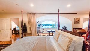 a bedroom with a bed with a large window at Snow Circle Retreat in Bourne