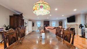 a living room with a chandelier and a table and chairs at Snow Circle Retreat in Bourne +89 photos
