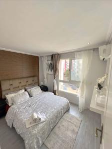 a bedroom with a large bed and a window at Chez alpha in Casablanca