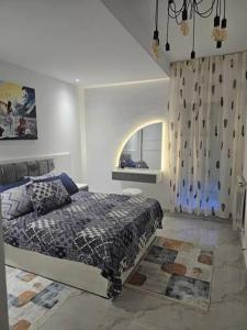 a bedroom with a bed and a window in it at Chez alpha in Casablanca