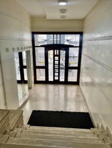 a hallway with stairs andwindows in a building at Chez alpha in Casablanca