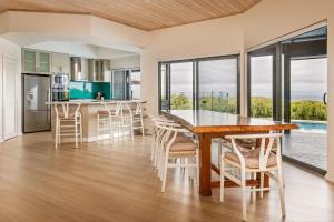 a kitchen and dining room with a table and chairs at Baudin Beach House in Gnarabup