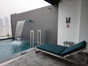 a room with a pool with a water fountain at One Budget Hotel Chiangrai Chiangsaen 2 in Ban Wiang Nuea