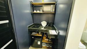 a small bathroom with a sink and a microwave at Chacara Stay in São Paulo +41 photos