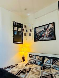 a bedroom with a bed and a picture on the wall at The Cozy Nest in Gurgaon