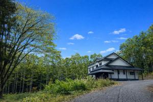 a house on the side of a road at Fuji-Kurohime- in Shinano