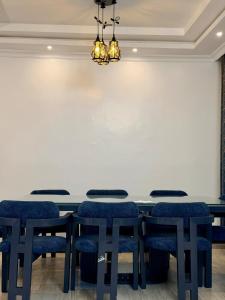 a conference room with a table and chairs in front of a large screen at Easternville 4 bedroom Maisonette in Nairobi