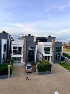 a person walking in front of a large building at Easternville 4 bedroom Maisonette in Nairobi