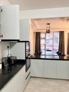 a kitchen with white cabinets and a black counter top at Easternville 4 bedroom Maisonette in Nairobi