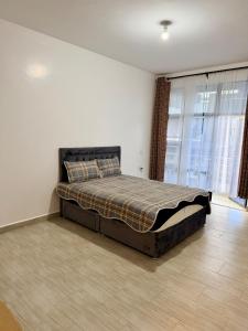 a bedroom with a bed in the corner of a room at Easternville 4 bedroom Maisonette in Nairobi +56 photos