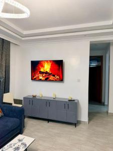 a living room with a fire on the wall at Easternville 4 bedroom Maisonette in Nairobi