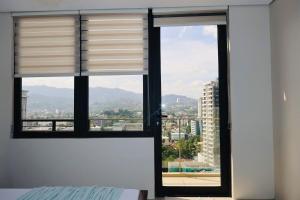 a window with a view of a city at Studio Getaway in Cebu City Baseline in Cebu City