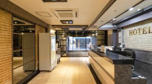 a lobby of a restaurant with a reception counter at Osan J Hotel in Osan