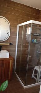 a glass shower in a bathroom with a mirror at Villa Nostra in Ngaparou +16 photos