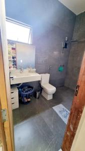 a bathroom with a sink and a toilet at Milla villa in Alligator Pond Village