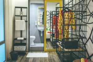a bathroom with a toilet and a mirror at Dash Box Hotel Cyberjaya in Cyberjaya