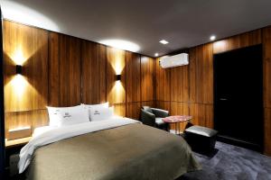 ein Schlafzimmer mit einem Bett, einem Schreibtisch und einem Stuhl in der Unterkunft Cielo HOTEL in Seosan