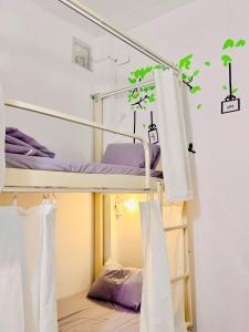 a dorm room with bunk beds with white curtains at Da Nang Sleepbox & Dorm in Danang +28 photos