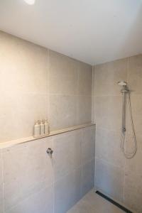 a bathroom with a shower with a shower head at Selah Valley Estate in Limpinwood +57 photos