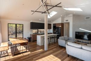 a living room with a couch and a table at Selah Valley Estate in Limpinwood