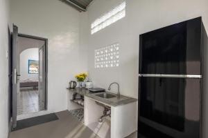 a white kitchen with a sink and a mirror at O'Stay Vinh Hy in Vĩnh Hy