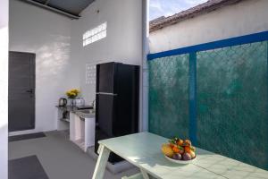 a kitchen with a table with a bowl of fruit on it at O'Stay Vinh Hy in Vĩnh Hy