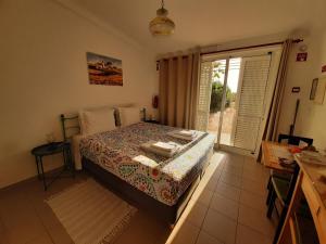 a bedroom with a bed and a large window at Quinta do Maranhão in Lagos +86 photos