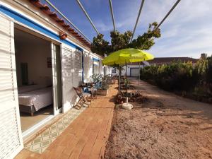 a patio with an umbrella on a house at Quinta do Maranhão in Lagos