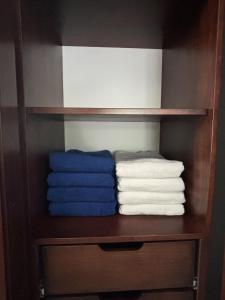 a closet with some towels on a shelf at Luxury Riverfront House 3BR BBQ Jungle views & walk to river in Parrita +105 photos