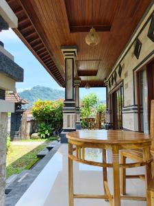 an outdoor patio with a wooden table and chairs at Okasarna Guesthouse in Sidemen +10 photos