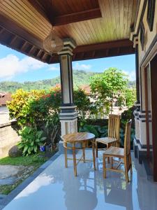 two chairs and a table on a porch with a view at Okasarna Guesthouse in Sidemen