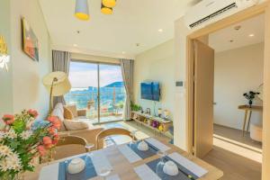 a living room with a couch and a table at The Sóng Vũng Tàu - Căn Hộ Nghỉ Dưỡng, Infinity Pool - Near Beach & Central Location Mr T in Vung Tau