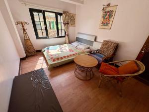 a room with a bed and a table and chairs at Monkey Temple Homestay in Kathmandu