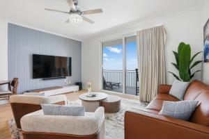 a living room with a couch and a tv at Splash Resort, 16th floor, Oceanfront, 1BR Sleeps 6, Lazy River & Water Park in Panama City Beach