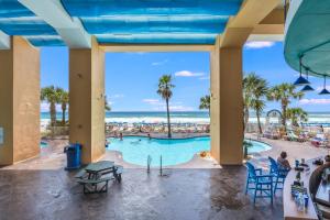 a view from the lobby of a resort with a pool and the ocean at Splash Resort, 16th floor, Oceanfront, 1BR Sleeps 6, Lazy River & Water Park in Panama City Beach
