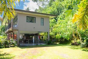 a house with a yard in front of it at ARIIMOE Hava'e in Teahupoo