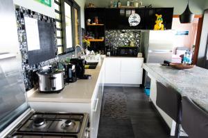 a kitchen with a stove and a counter top at ARIIMOE Hava'e in Teahupoo