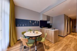 a kitchen and dining room with a table and chairs at Citadines Namba Osaka in Osaka