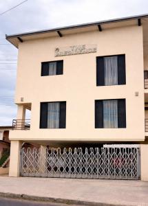 a building with a fence in front of it at Trendy Edge Apartments in Nadi