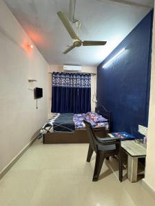 a bedroom with a bed and a chair and a table at Sky cottage in Jāmb